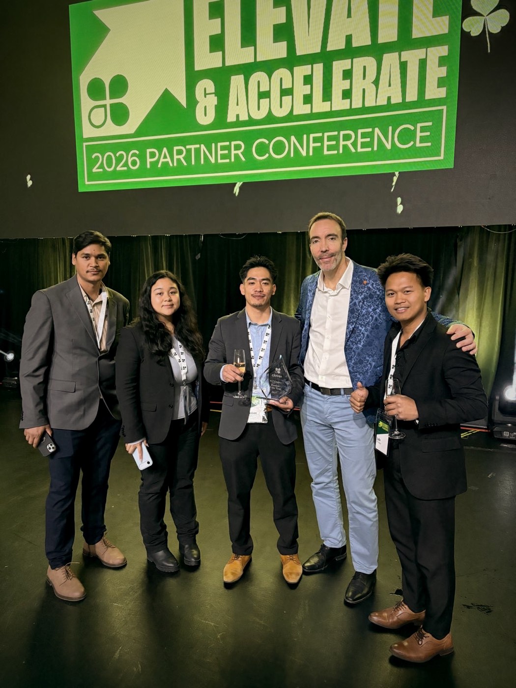 GT Legacy leadership with a Clover executive on stage at the Elevate and Accelerate partner conference