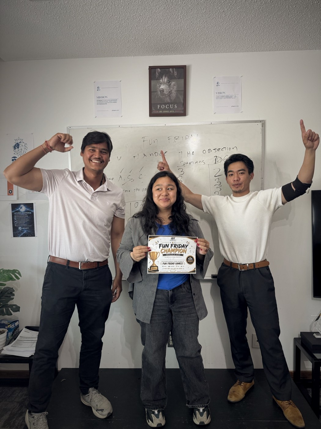 Three team members celebrating a Fun Friday win